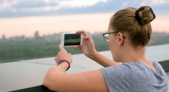 girl taking picture with phone